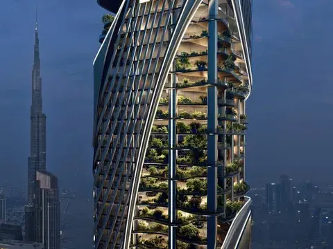 Planted terraces along the tower's curved facade at dusk